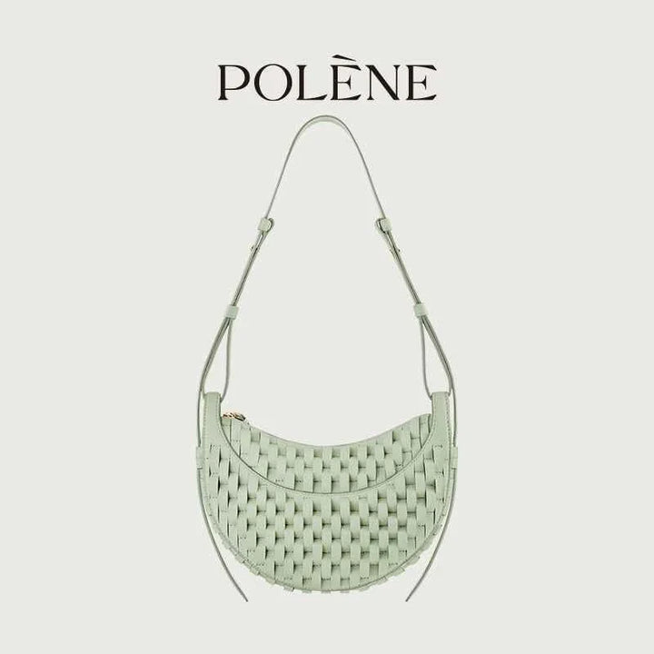 Polène Numéro Dix handwoven leather shoulder bag in almond green with curved crescent design and intricate weaving inspired by traditional horse saddlery craftsmanship.