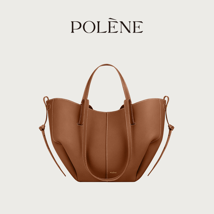 Polène Cyme Mini brown leather tote bag with soft curves, dual open and closed flower-like design, short and long shoulder straps, and removable inner pouch.