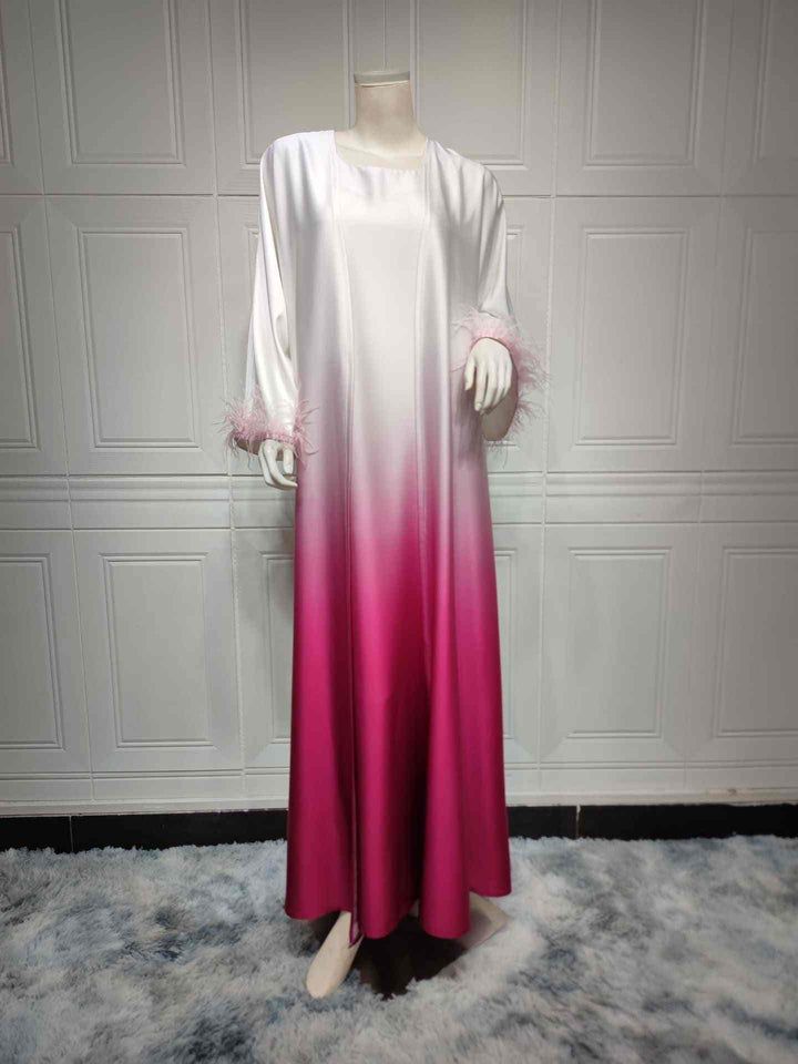 Elegant satin abaya with color gradient and feather-trimmed sleeves.