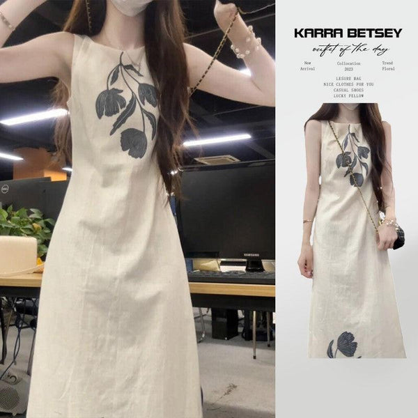 Sleeveless off-white floral casual dress with a flowing design.