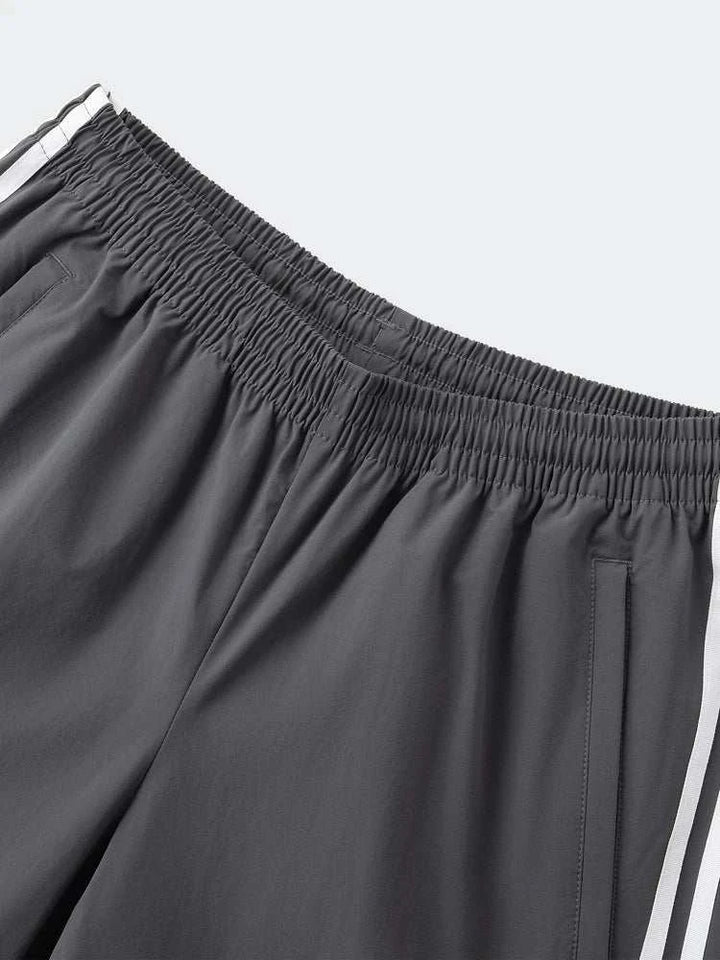 Adidas بنطال رياضي قابل للفصل رمادي بخطوط بيضاء للرجال والنساء بخصر مطاطي وجيوب