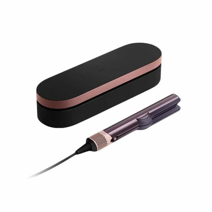 Dyson Airstrait hair straightener and dryer combo with sleek black and rose gold design and carrying case