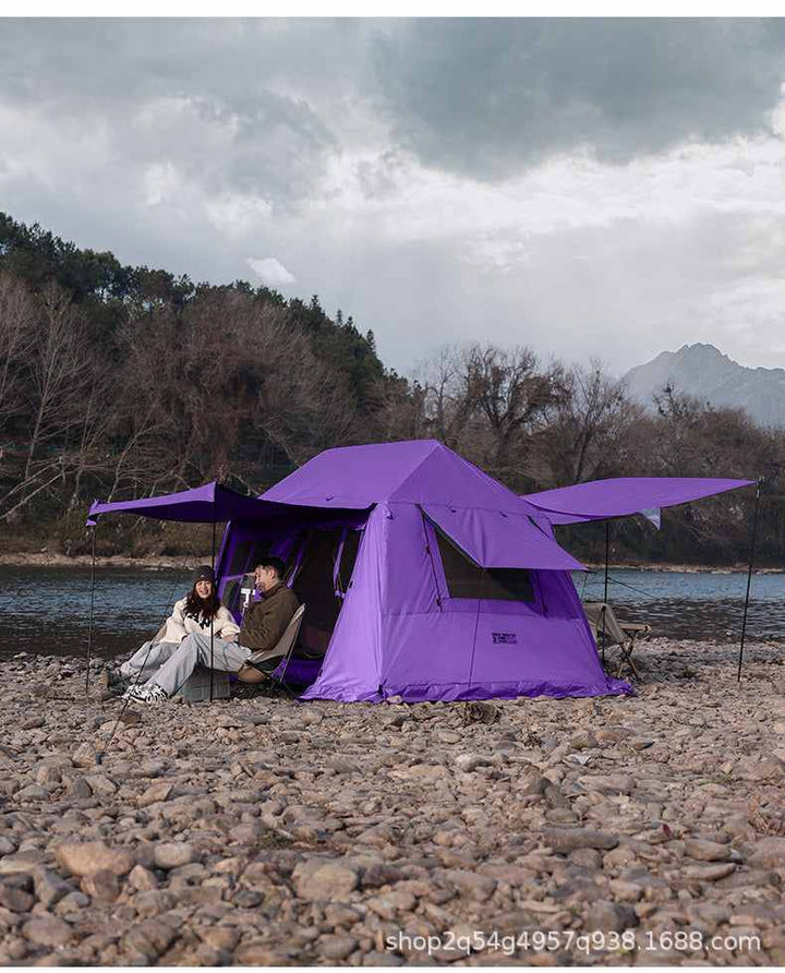Wolf Walker Cloud Pavilion inflatable purple camping tent with large canopy set up by a river in outdoor wilderness.