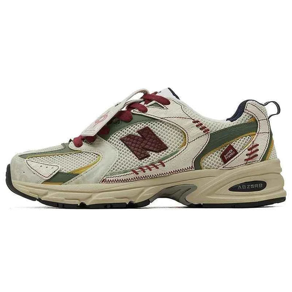 New Balance 530 sneaker in limited edition PandaPrank design with beige, olive green, dark red accents, mesh and leather details, and Abzorb cushioned sole