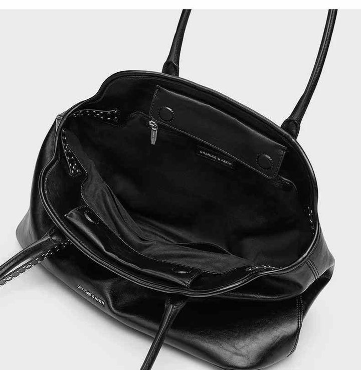 Open black CHARLES&KEITH large leather shoulder bag with multiple compartments and magnetic closure