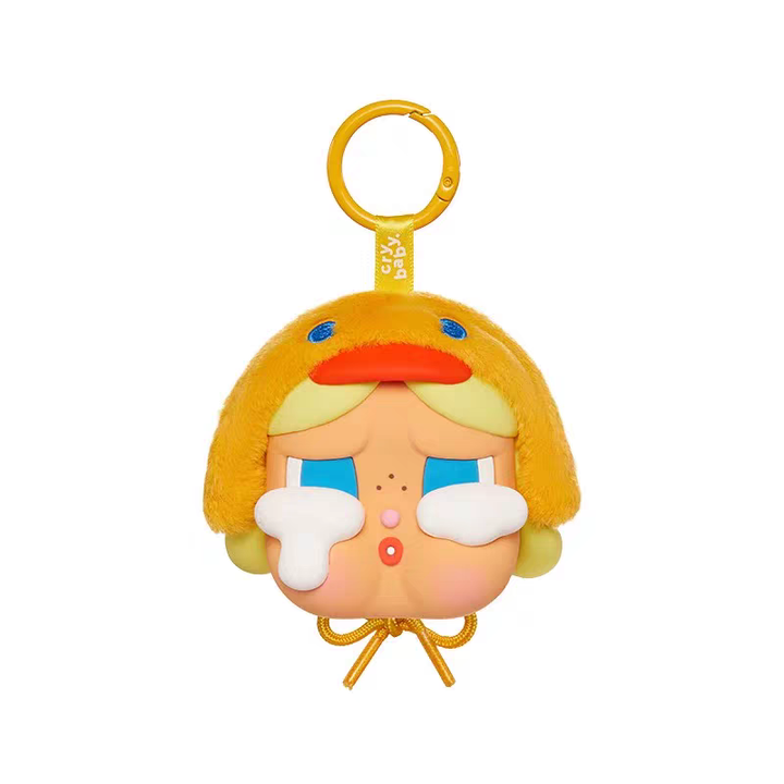 Yellow duck hat Crybaby keychain with large white tears and sad expression, plush texture, cute cartoon design