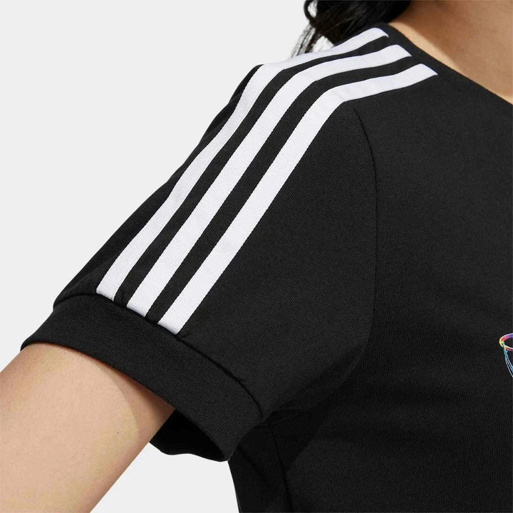 Close-up of black Adidas t-shirt sleeve with iconic three white stripes and graffiti-inspired design for a youthful look.
