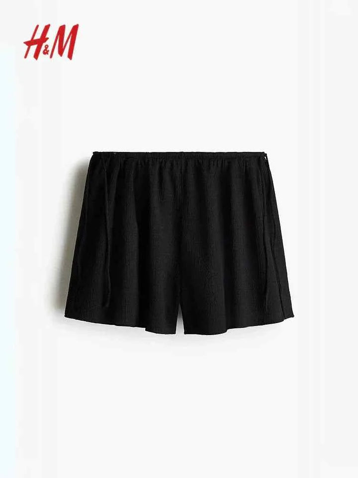 Black crinkled jersey shorts with high elastic waist and side ties, HM.