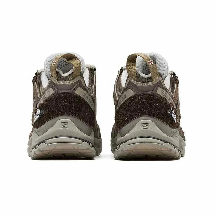 Rear view of Salomon XA Pro 3D Ice Warrior limited edition hiking shoes in earthy brown and beige tones with rugged Contagrip soles and mountain-inspired rope laces.