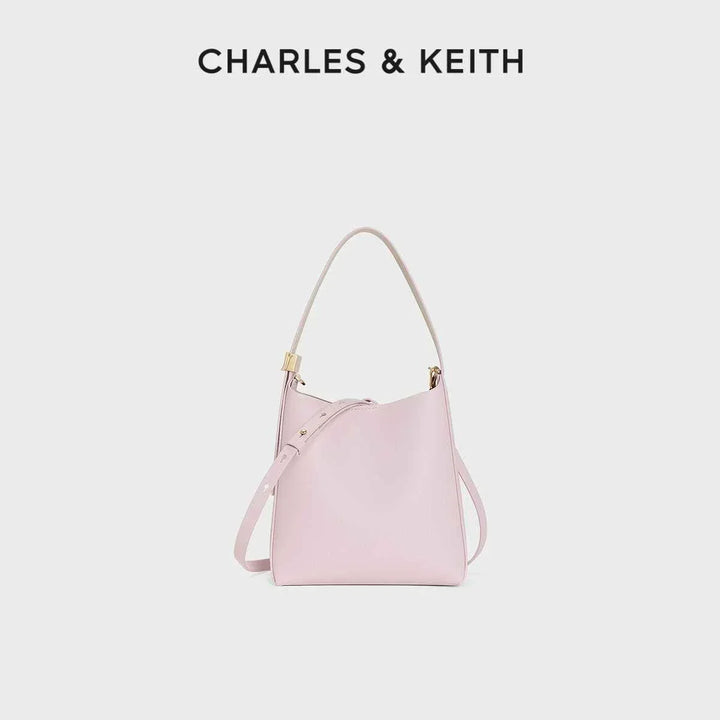Small pink shoulder bag with matching wallet by CHARLES & KEITH elegant leather design