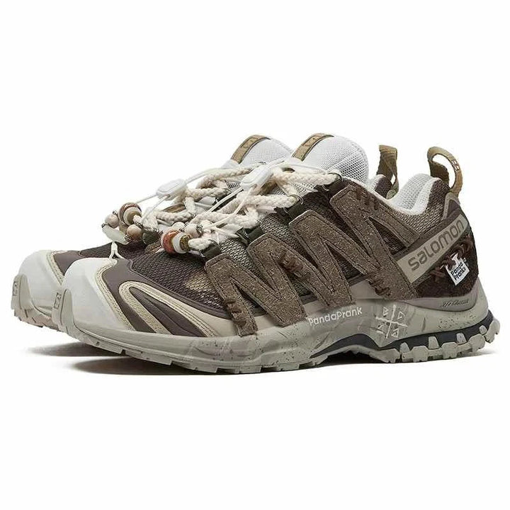 Salomon XA Pro 3D Ice Warrior Limited Edition hiking shoes in earthy brown and cream tones with Contagrip soles and mountain-inspired rope laces.
