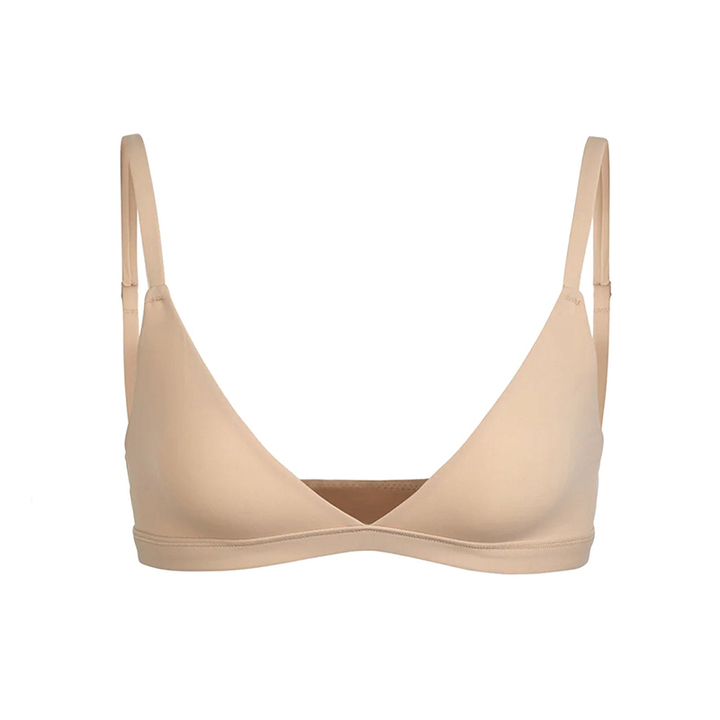 Beige SKIMS triangle bralette with soft fabric and adjustable straps for comfortable daily wear.