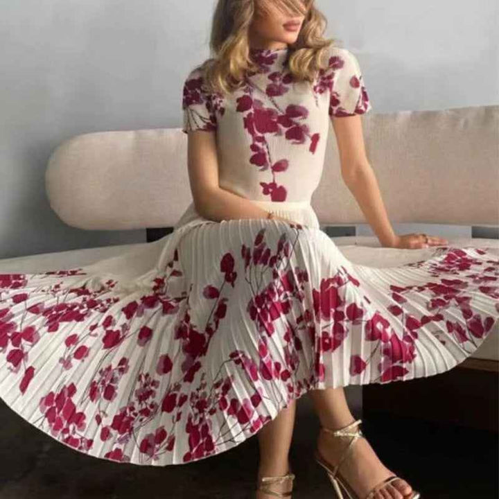 Elegant floral pleated midi dress with short sleeves, perfect for special occasions and stylish everyday wear.