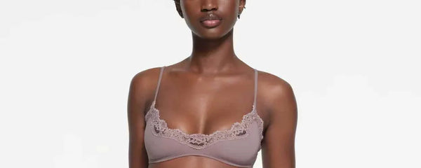 woman wearing SKIMS Fits Everybody lace scoop bralette and matching lace camisole vest in mauve color