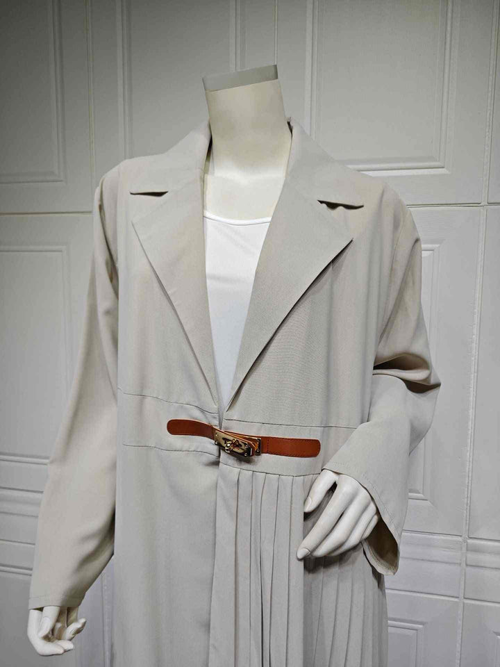 Elegant pleated trench coat with belt and gold buckle, classic long design, available in black and beige.