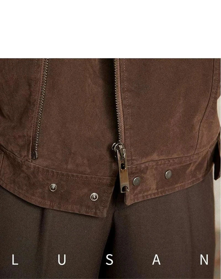 Mr. Lusan English jacket close-up of brown suede-like fabric with metal zipper and snap buttons detailing