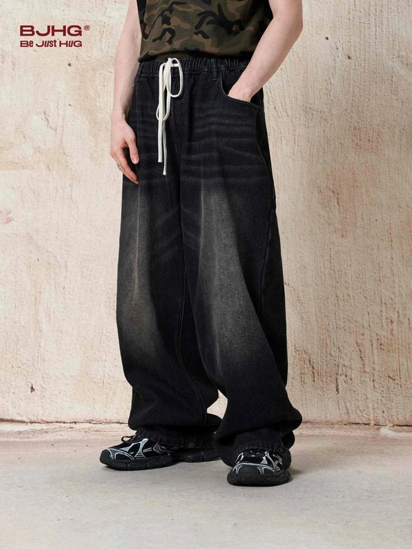 wide black denim jeans with white drawstring and relaxed fit for casual style الب جينز