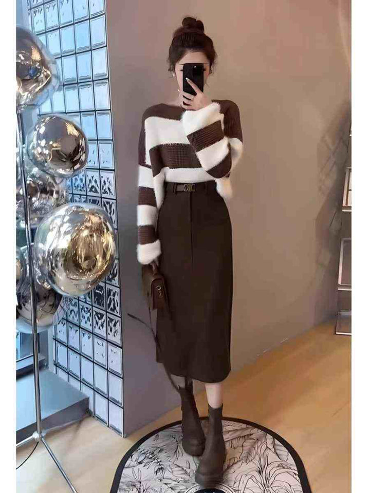 Elegant winter outfit with striped cardigan and brown midi skirt, styled with boots for a chic seasonal look