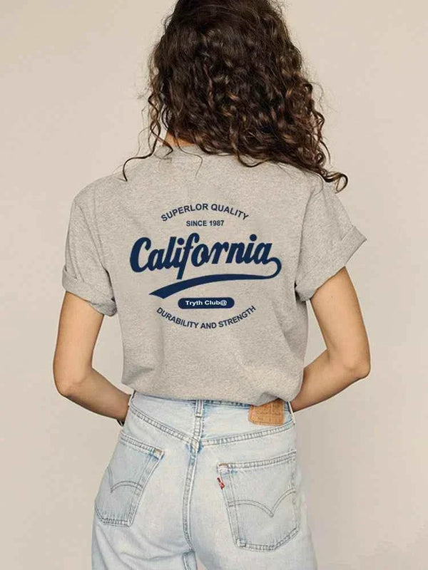 gray California Club casual t-shirt with bold back print worn with light blue jeans