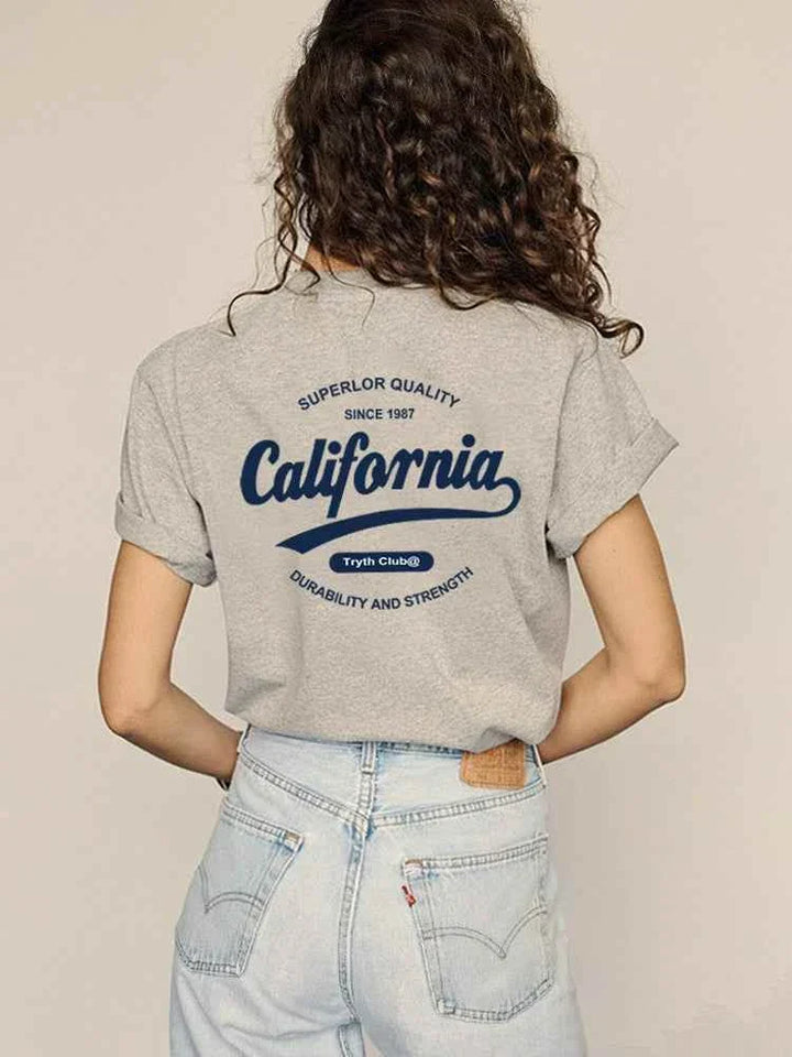 gray California Club casual t-shirt with bold back print worn with light blue jeans