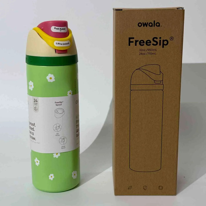 Owala Thermos CupKitty Limited Edition with green floral design, leak-proof stainless steel FreeSip water bottle with dual spout and safety lock next to its packaging box