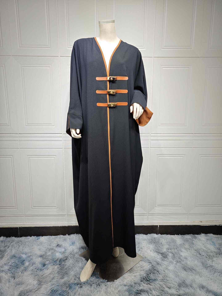 Modest fashion abaya with leather belts, color-blocked design, and Turkish-inspired style.