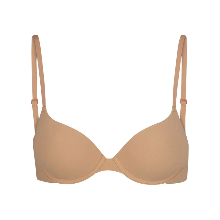 Soft supportive beige bra with adjustable straps by SKIMS, seamless design with light underwire cups for daily comfort and natural lift