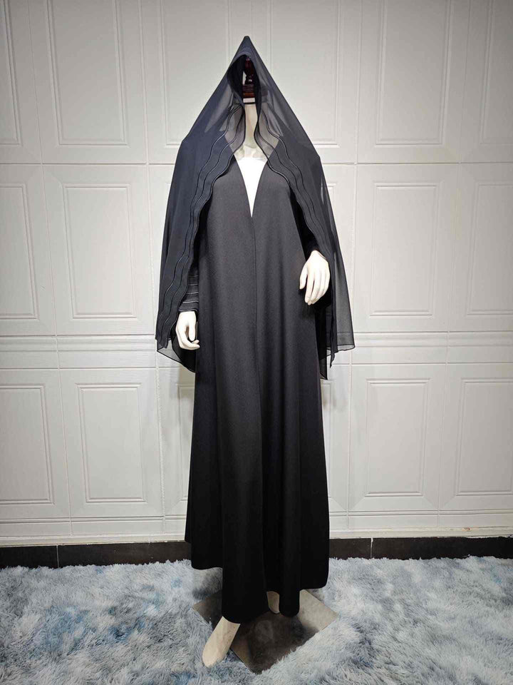 Luxury abaya with modern design and elegant lines, featuring wavy sleeve details, made from soft, exquisite fabric, paired with a matching hijab.