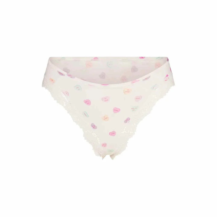 SKIMS Fits Everybody lace dipped thong in printed white with delicate lace and colorful heart patterns