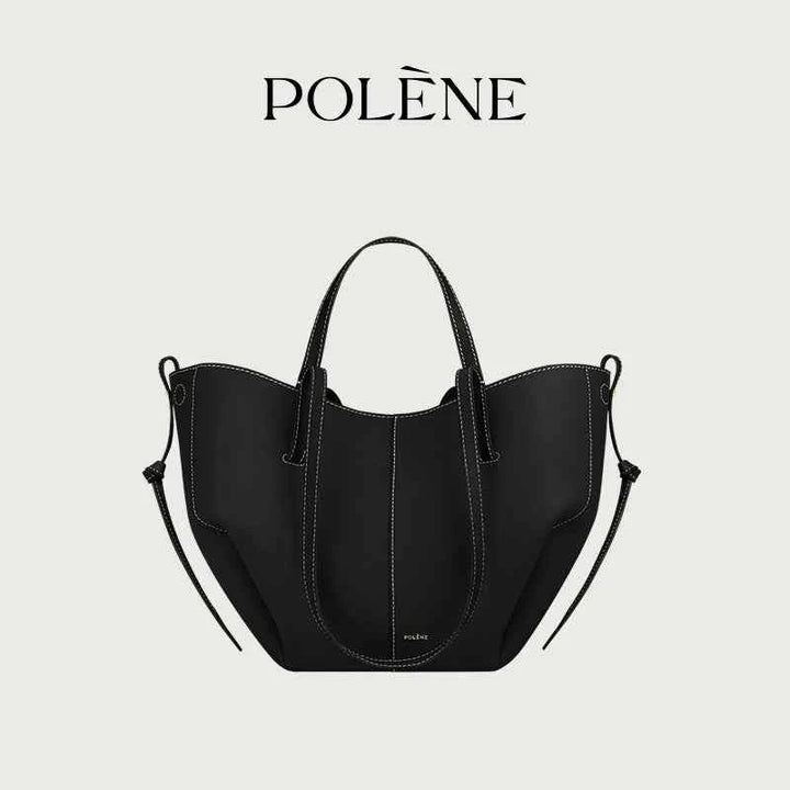 Polène Cyme Mini black leather tote bag with soft curves, dual-use design, and contrast white stitching.