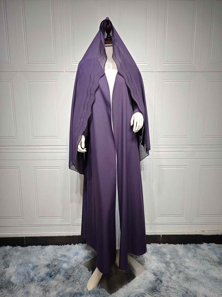 Elegant modern abaya with wavy lined sleeves, luxury fabric, matching hijab, Autumn 2023.