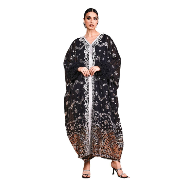 Luxurious black dress with Eastern embroidery and fur-trimmed wide sleeves, perfect for upscale occasions.