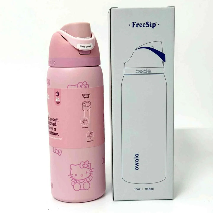 Pink Owala FreeSip stainless steel water bottle with Hello Kitty design and dual spout beside its packaging box