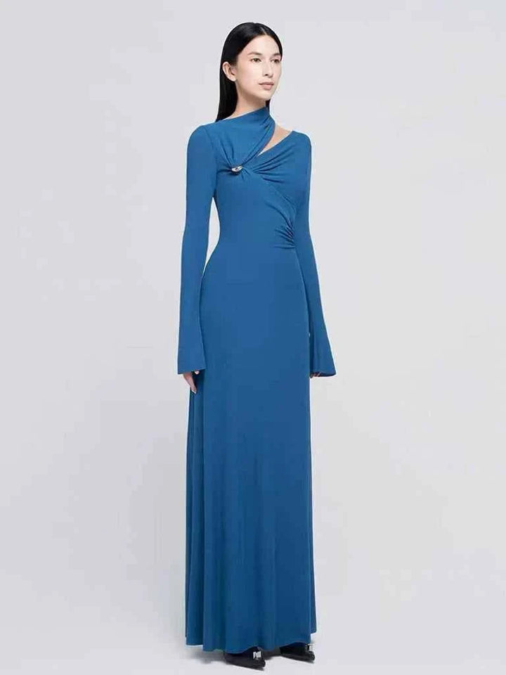 blue long sleeve evening maxi dress with asymmetric neckline and silver pin detail