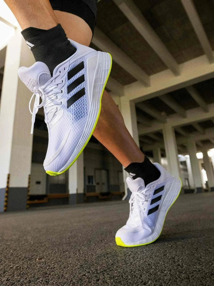 Adidas أديداس حذاء DURAMO SL شبكي أبيض بثلاث خطوط سوداء ونعل أصفر فسفوري للجري والتدريب اليومي