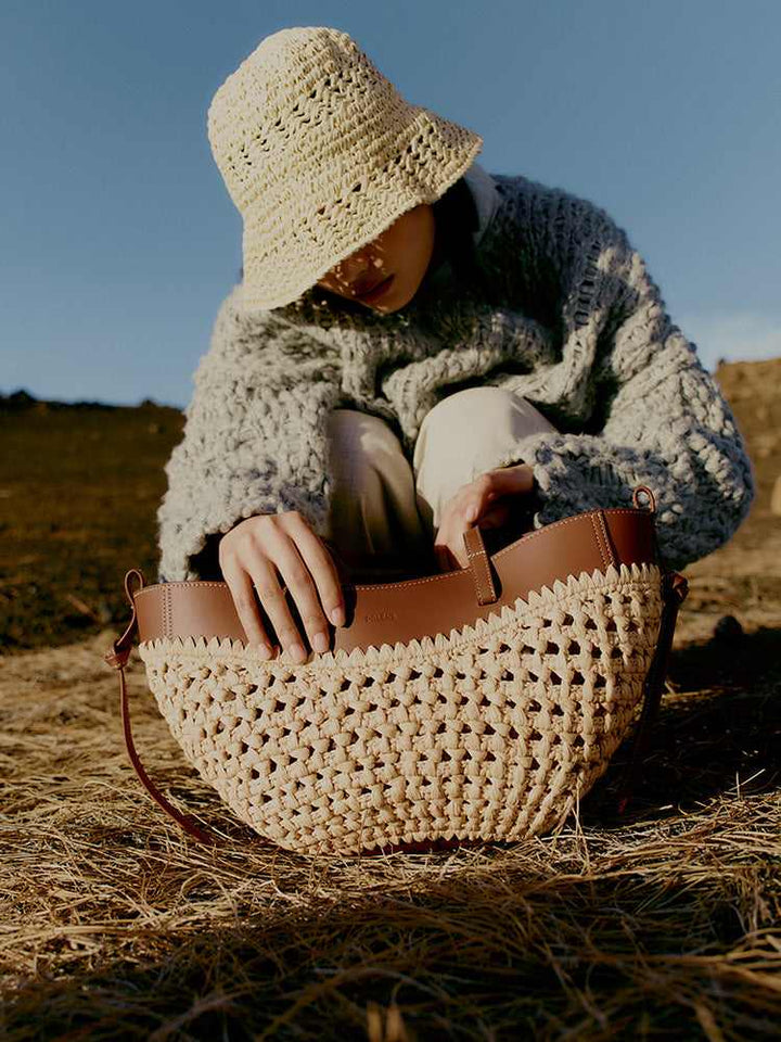 Polène Cyme raffia bag with cowhide leather details, handmade crochet design, adjustable shoulder strap, natural woven texture.