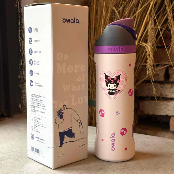 Owala FreeSip stainless steel water bottle with dual spout and leak-proof design in purple and beige color with cartoon print next to packaging box