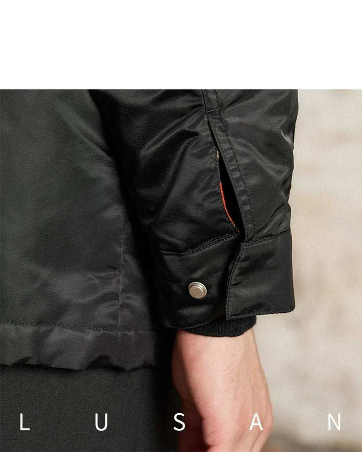 Close-up of black water-resistant lightweight Mr. Lusan jacket Italian with metal snap cuff and detailed stitching