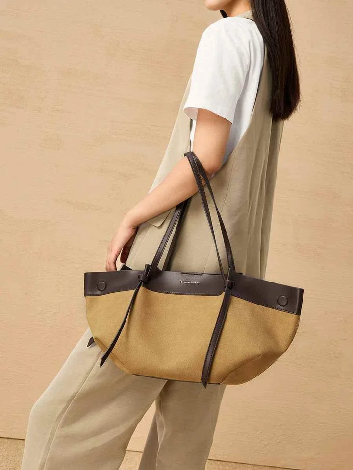 CHARLES &KEITH large two-tone tote bag with small inner pouch, beige and dark brown design, worn by woman, practical and stylish accessory