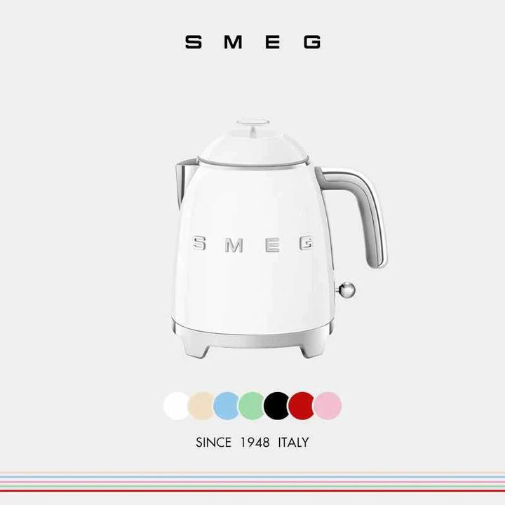 Small white SMEG electric kettle with Italian design, 0.8L capacity, stainless steel spout, and heat-resistant handle.