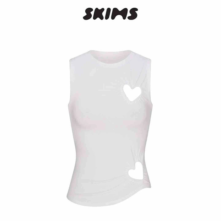White SKIMS Kardashian sleeveless fitted top with open heart cutouts on chest and abdomen