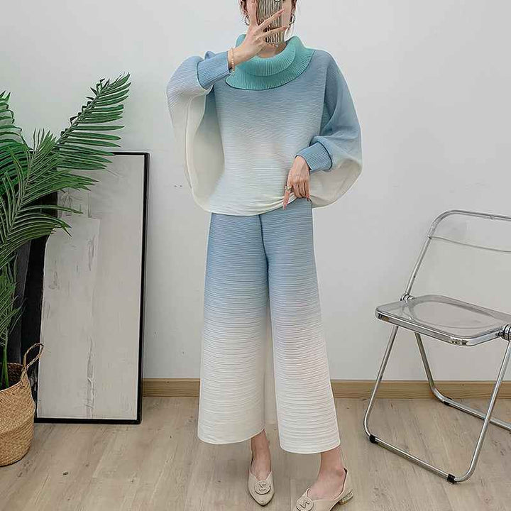 Pleated gradient suit 2025 spring with high-neck blouse and wide pants in soft color tones.