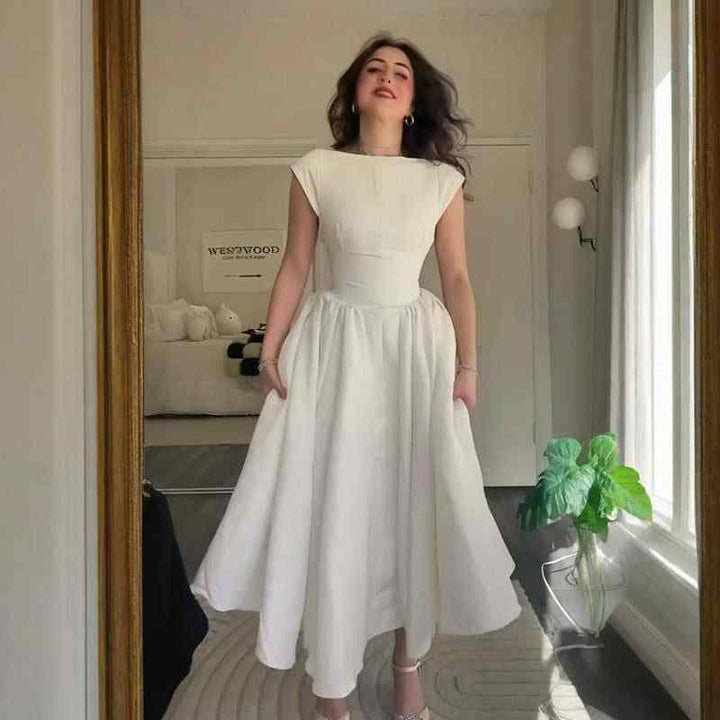 Elegant white vintage-inspired classic dress for 2025 summer, featuring a fitted waist and A-line skirt.