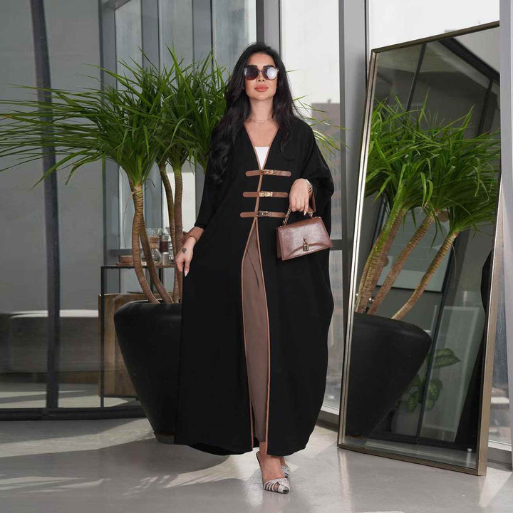 Modest fashion abaya with leather belts, color-blocked design, open front.