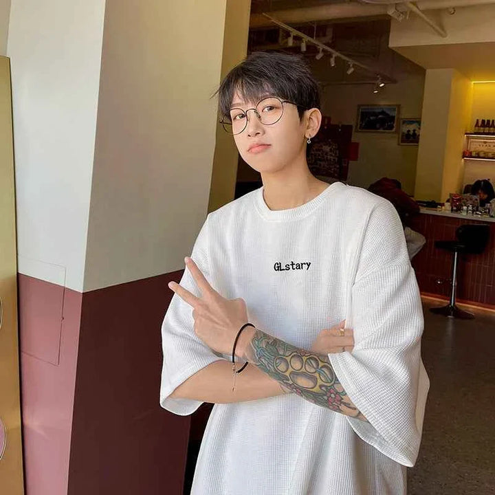 Young person wearing comfortable wide white تيشيرت MORRYING with casual style indoors