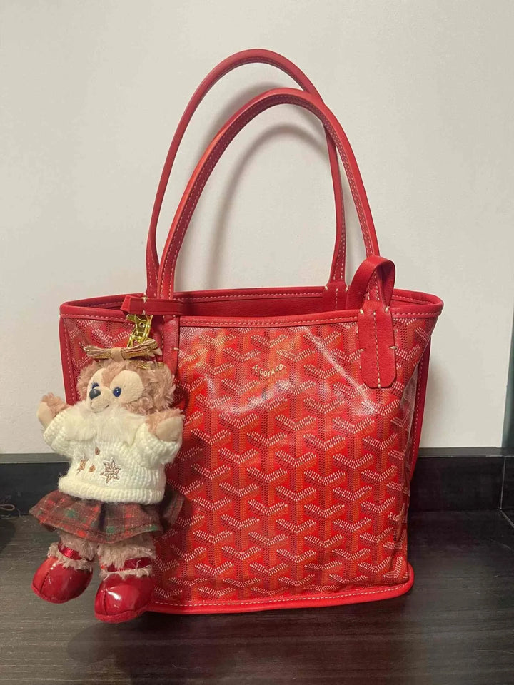red hobo bag حقيبة كتف with geometric print and leather strap with attached plush doll keychain