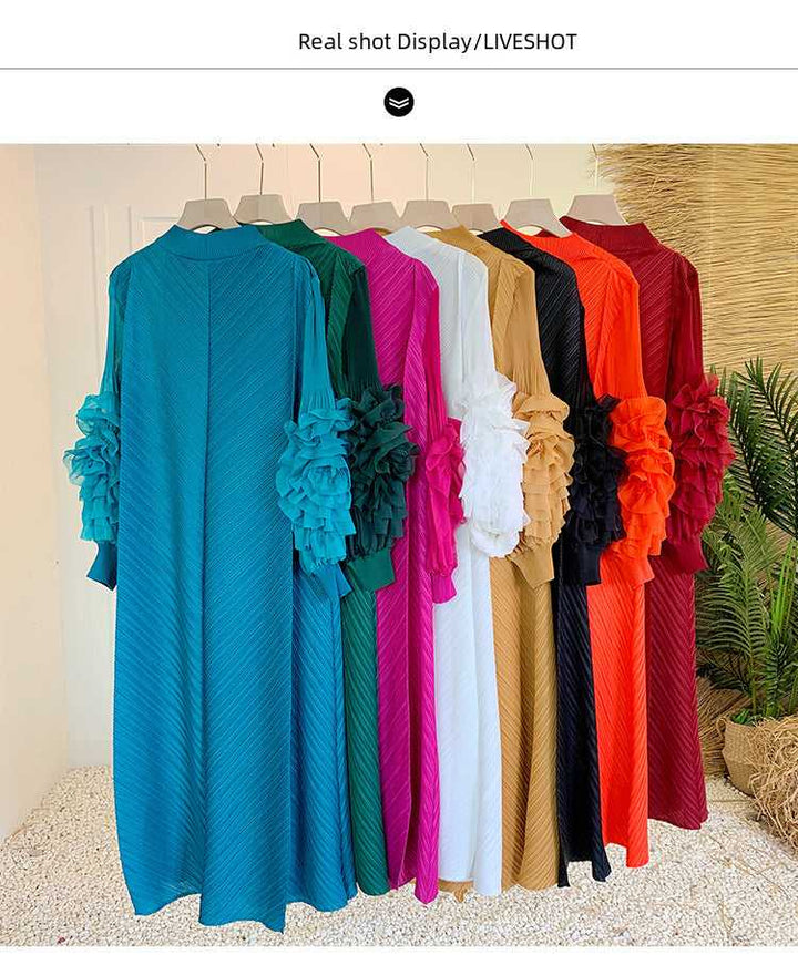 Solid color long loose dresses with floral adorned sleeves in various colors hanging on display.