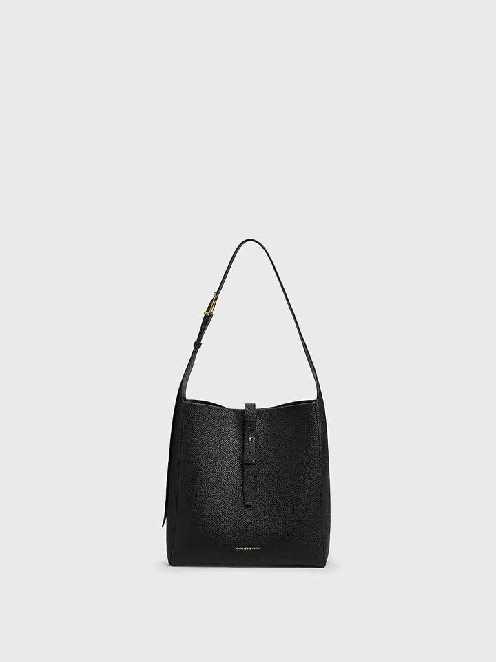 CHARLES KEITH black faux leather shoulder bag with adjustable strap and small inner pouch for organized daily use