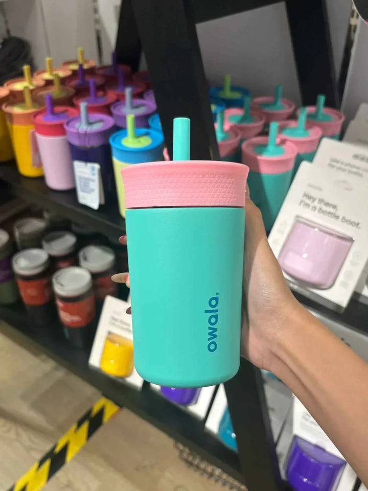 Owala FreeSip insulated bottle in mint green and pink with built-in straw, spill-proof and BPA-free, 12 oz capacity.