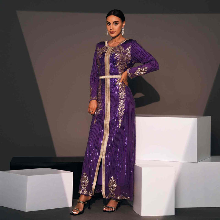 Luxurious Moroccan caftan in deep purple with elegant gold embroidery and shiny fabric.